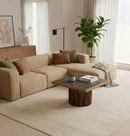Beige sectional sofa with decorative pillows in a living room setting.