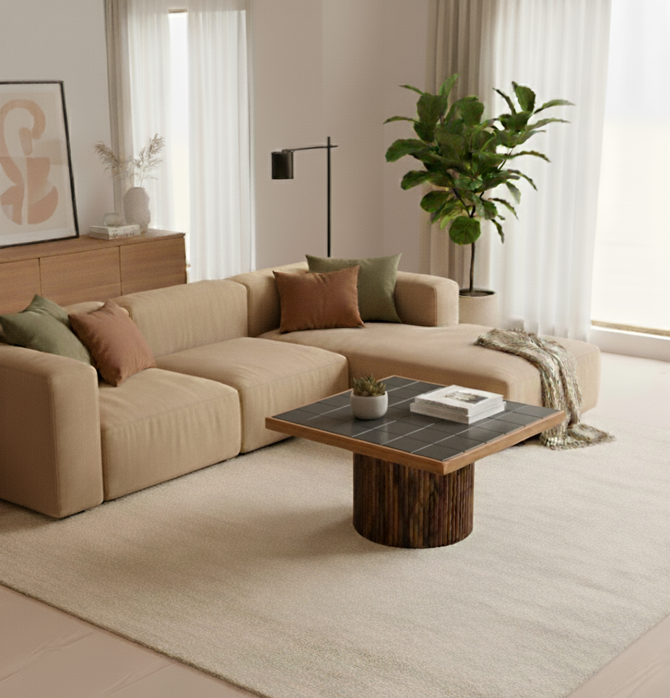 Beige sectional sofa with decorative pillows in a living room setting.