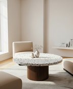 Modern living room with a round terrazzo coffee table and beige sofa.