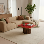 Modern living room with beige sectional sofa, red coffee table, and decorative elements.